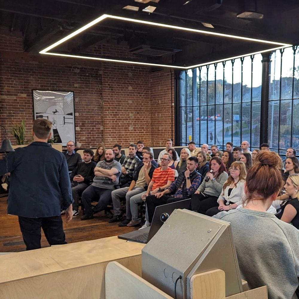 Ben Payne Hunt sat at the front of a crowd at a confernce